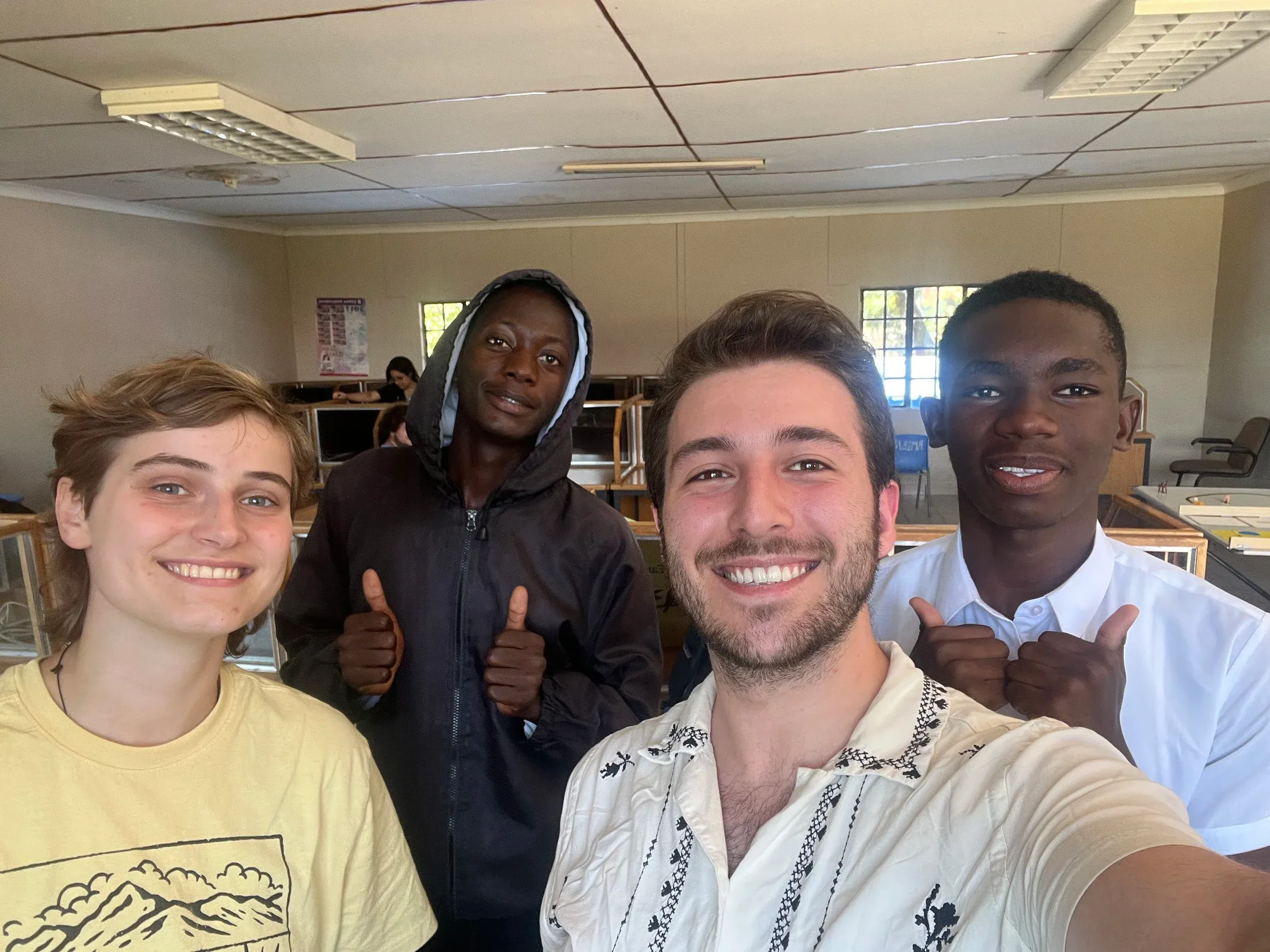 A selfie with three students in a computer lab
